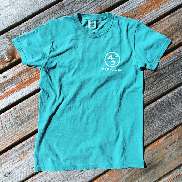 Sea Foam Blue 45th Parallel Puff Ink Activity Tee on wooden background