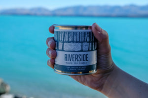 Northwoods Candle in Riverside held near water