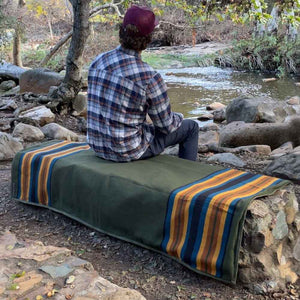 45th Parallel Canvas Waterproof Outdoor Blanket spread on rocks by river
