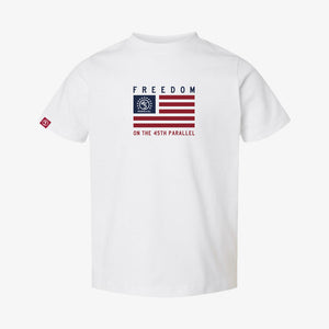 Freedom Flag Toddler Tee in Alpine White — front view with horizontal flag graphic