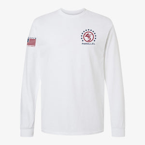 Freedom Star Badge Long Sleeve in Alpine White — front view with chest badge and sleeve flag